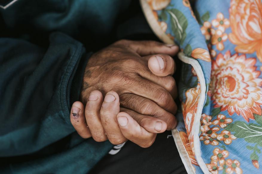 218561666-homeless-man-holding-his-hands