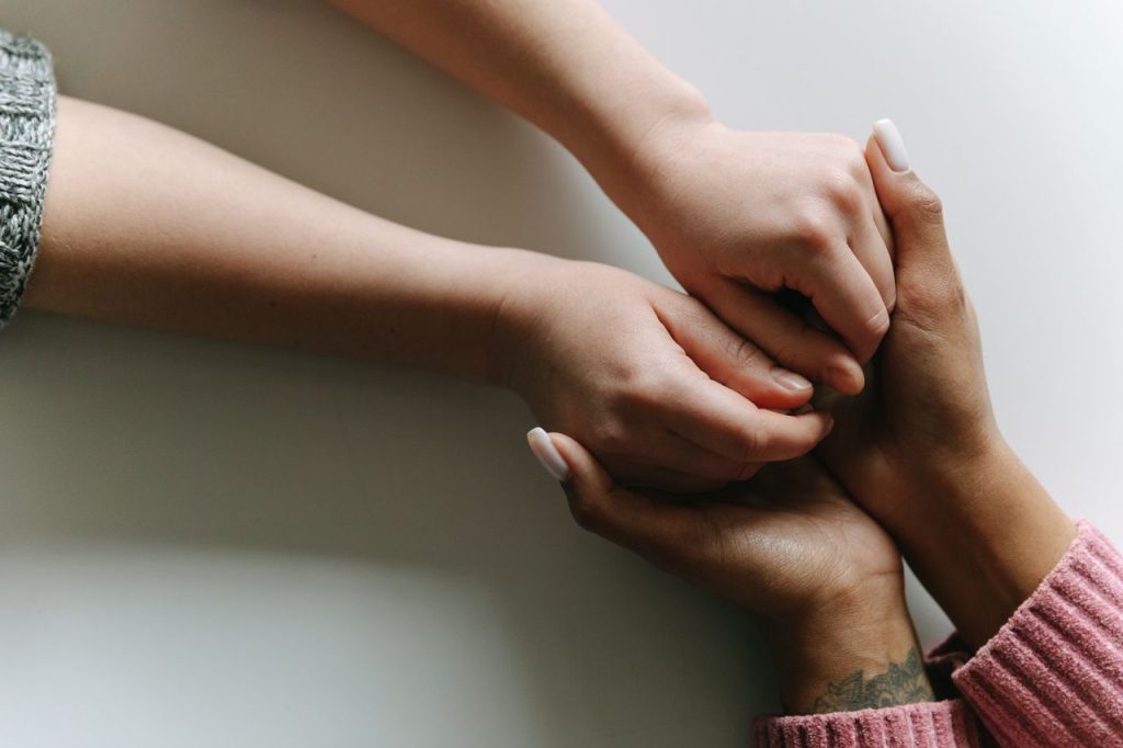 Home Close-up of diverse hands holding, symbolizing care, support, and friendship.